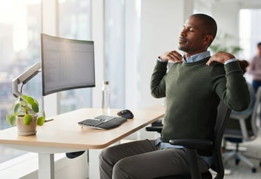 Employee performing shoulder rolls during a short office stretching break.