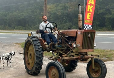 Shop owner driving around a tractor that he just fixed