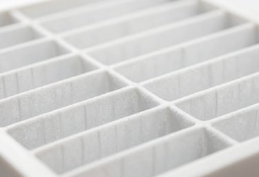 Macro shot of a clean, white AC air filter, symbolizing hygiene and pure air quality, bright and precise lighting.