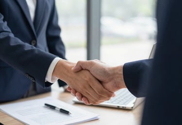 A friendly immigration officer assisting a client with visa paperwork in a bright, welcoming environment.