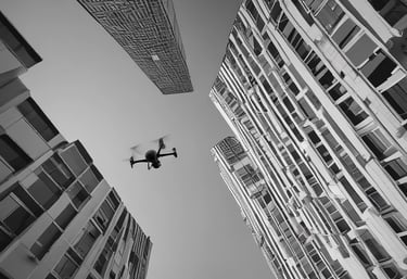 A black and white image showing a filmmaker adjusting camera settings on location.