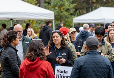 A team workshop with leadership coaching and training materials spread out on a rustic wooden table.
