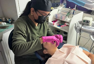 a woman is getting her teeth brushed up and ready to be a dentist