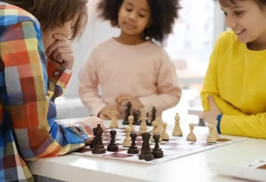 a group of children playing chess in a room