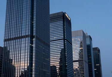 High-rise skyline at dusk in a global financial center, reflecting professional ambition, featuring Dark Navy Blue and Steel Blue tones.