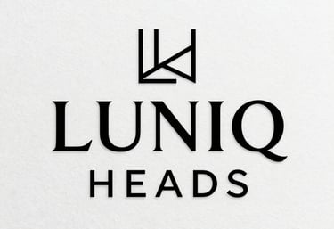 An elegant corporate logo for LUNIQ HEADS featuring minimalist geometric lines and refined sans-serif typography on a white textured background.