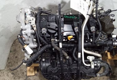 Used car parts with intake manifold and wiring harness on a pallet.