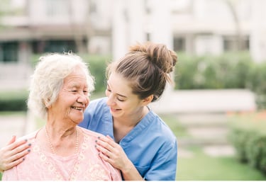 Caregiver smiling with an elderly woman 