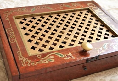 a wooden box with a golden handle
