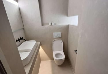 a bathroom with a toilet and a sink fitted by pbp services in droitwich