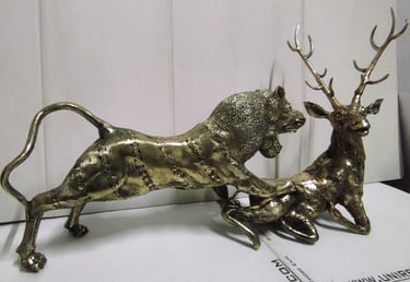 "Decorative brass piece depicting a lion chasing a deer-Globally tradable"