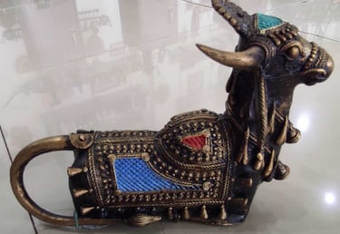  "Handcrafted brass bull sculpture with red and blue accents on the back – tribal-style-for overseas demand"