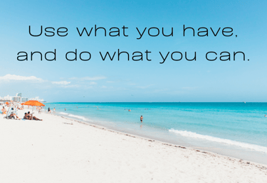 a beach with people sitting on the sand
