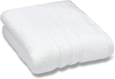 Soft white cotton bath towel folded neatly, showing plush texture and ribbed decorative border.