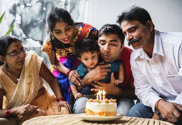 a family celebrating a birthday party with a cake