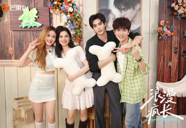 Cast members of the Chinese drama Longman Fengzhang posing together with bone-shaped plush pillows.