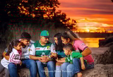 a family of five sitting on a rock wall