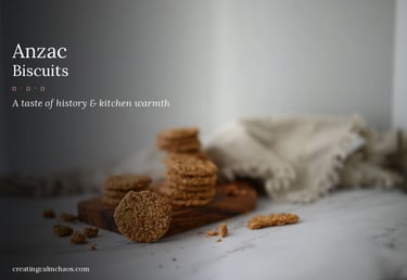 A stack of homemade golden Anzac biscuits with sesame seeds on a wooden board.