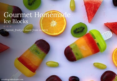 Gourmet homemade ice blocks featuring colorful layered fruit purees surrounded by fresh kiwi, orange, and watermelon slices.