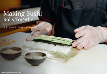 A chef in a black apron and gloves prepares fresh sushi rolls with cucumber and rice on a bamboo mat.