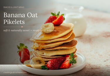 Stack of banana oat pikelets topped with fresh strawberries, sliced bananas, and drizzled honey.