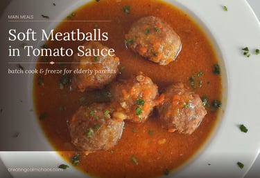Soft meatballs served in a savory tomato sauce with herbs, a freezer-friendly meal for elderly parents.