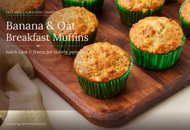 Freshly baked banana and oat breakfast muffins in green liners on a wooden board.