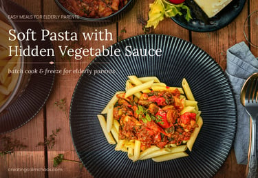 Soft penne pasta with hidden vegetable sauce served on a dark plate, ideal as easy meals for elderly parents.