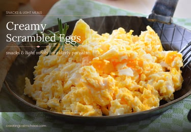 Creamy scrambled eggs served in a skillet, an easy soft food snack for elderly parents.