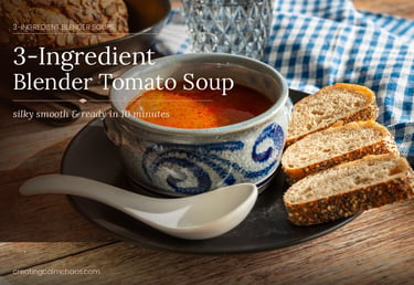 Homemade 3-ingredient blender tomato soup served in a blue ceramic bowl with crusty bread slices.