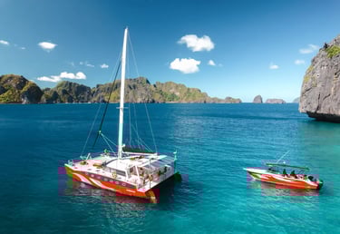 Private luxury yacht cruising through Bacuit Bay, El Nido.