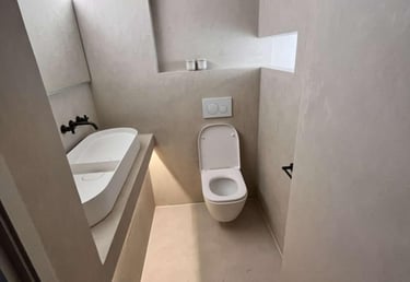 a bathroom with a toilet and a sink fitted by pbp services in droitwich