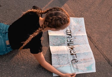 a single person reads a map of the world