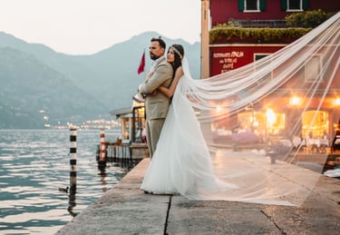 a bride and groom standing on a pier in Malcesine
