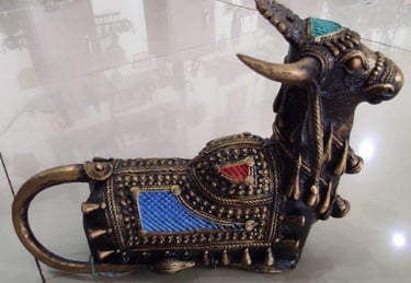  "Handcrafted brass bull sculpture with red and blue accents on the back – tribal-style-for overseas demand"