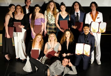 a group of people standing around a man holding a plaque