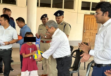 Manipur chief secretary Dr Vineet Joshi  presents gifts to children at a relief camp
