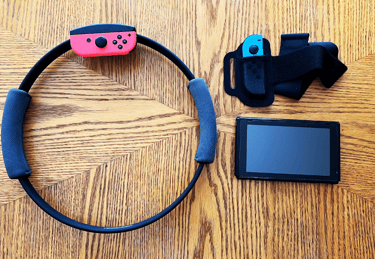 a nintendo wii game controller and Ring Fit Adventure