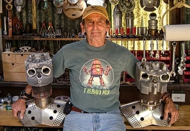 Talbotics t-shirt wearer with robot heads in the shop.