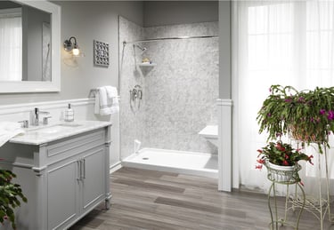 Elegant walk-in shower with marble walls and gray vanity from Toledo New Bath bathroom remodel.