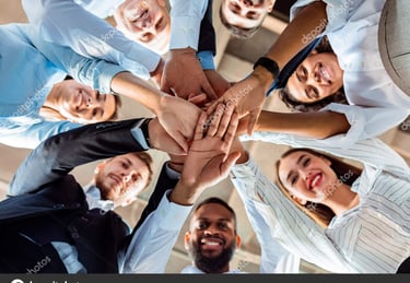 a group of business people standing in a circle with their hands together martin pe coach