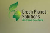 a green planet solutions logo on a wall