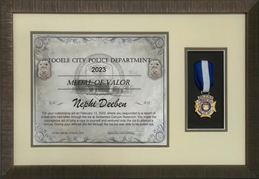 Framed Tooele City Police Department Medal of Valor certificate and award medal for Nephi Deeben.