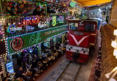 A locomotive pulls into the train street of the Old Quarter, where many bars with visitors are locat
