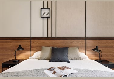 Sophisticated bedroom with natural walnut finishes, custom art pieces, and balanced design by SAVIA