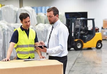 Warehouse workers reviewing survideo with integrated video surveillance and access control