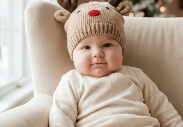 a baby wearing a reindeer hat and a reindeer hat