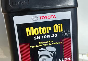 a person holding a motor oil canister