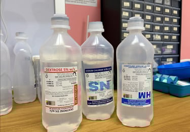 Three medical IV infusion bags containing Dextrose 5%, Sodium Chloride 0.9%, and Compound Sodium Lactate.