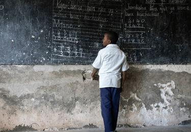 a man standing in front of a chalkboard with a chalkboard on it